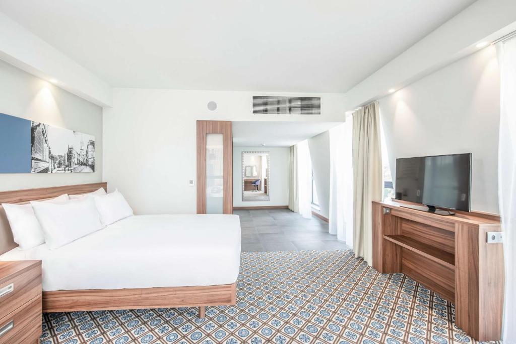 Televízia a/alebo spoločenská miestnosť v ubytovaní Hampton by Hilton Oswiecim