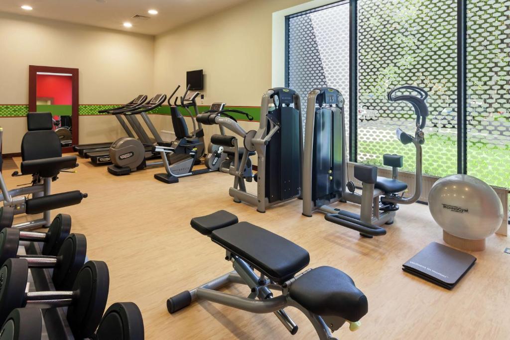 a gym with a lot of exercise equipment in it at Hampton by Hilton Warsaw Airport in Warsaw