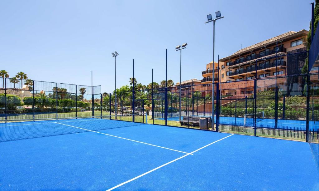a tennis court in front of a building at DoubleTree by Hilton Islantilla Beach Golf Resort in Islantilla