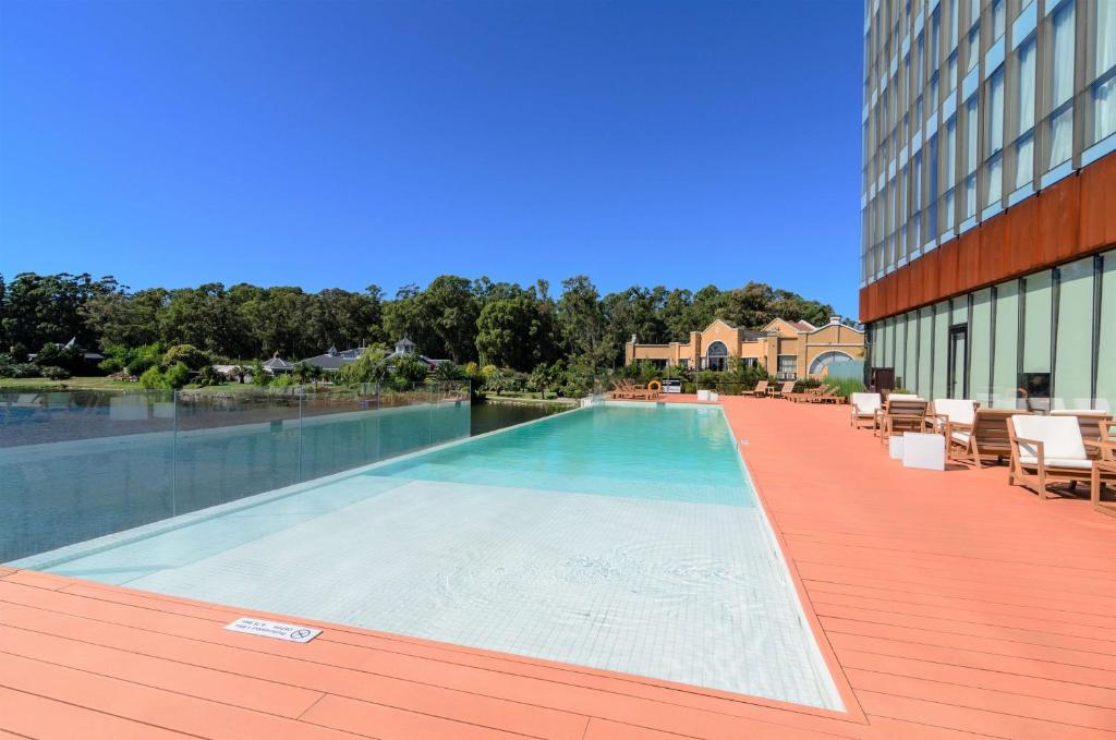 a swimming pool on the side of a building at Hampton By Hilton Montevideo Carrasco in Montevideo