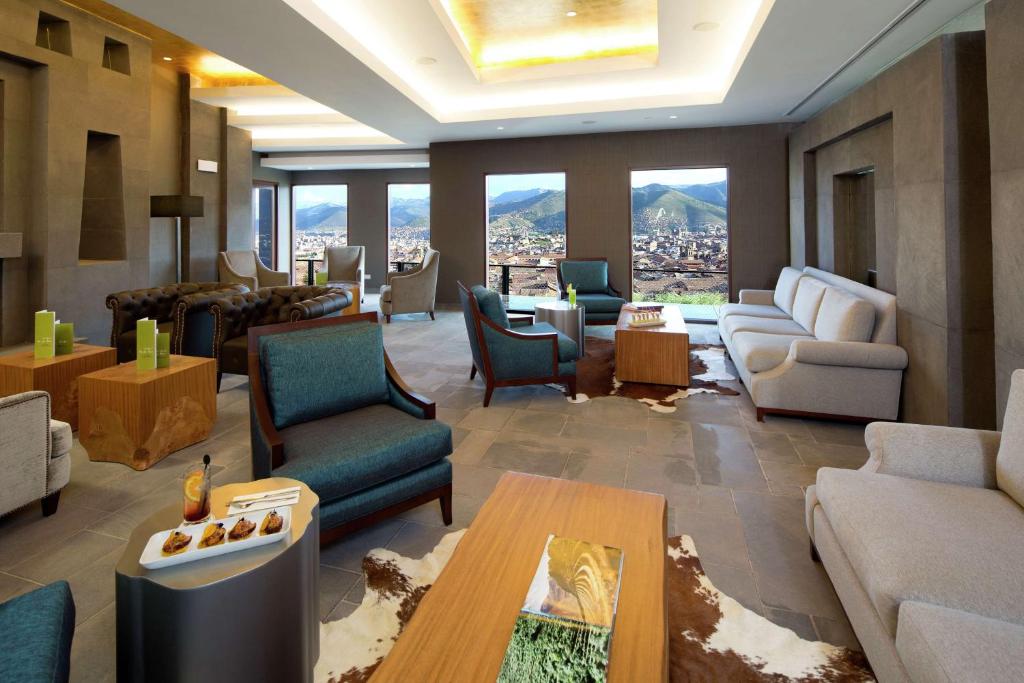 a living room with a view of a city at Hilton Garden Inn Cusco in Cusco