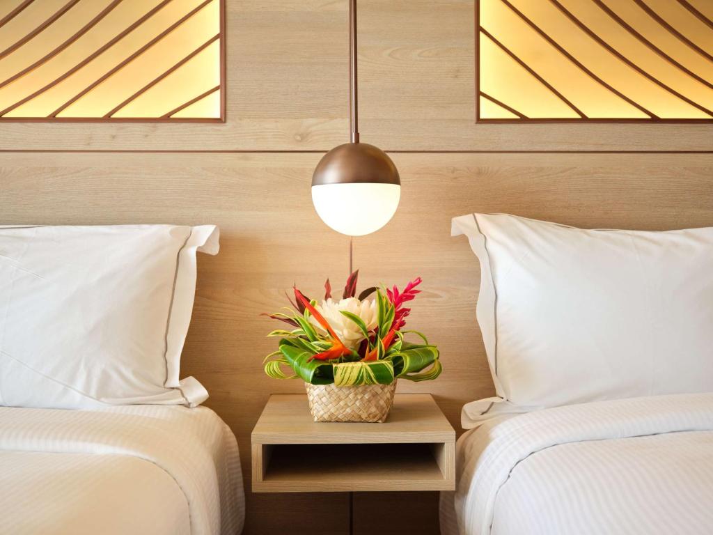 Postel nebo postele na pokoji v ubytování Hilton Hotel Tahiti