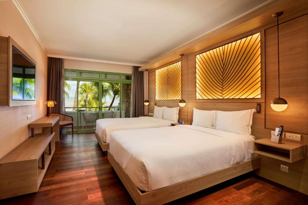 Postel nebo postele na pokoji v ubytování Hilton Hotel Tahiti