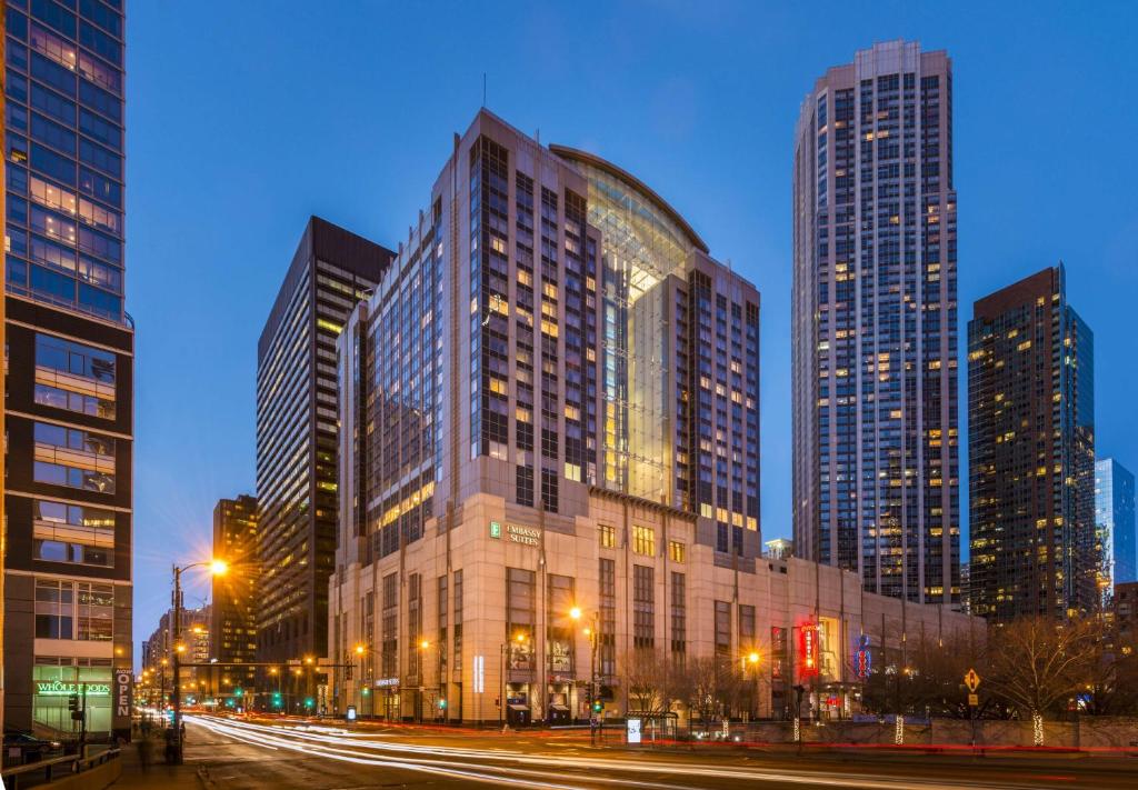 a large building in a city with tall buildings at Embassy Suites by Hilton Chicago Downtown Magnificent Mile in Chicago