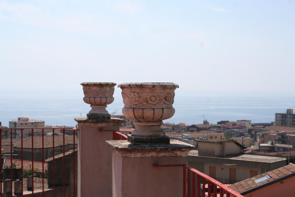 a pair of vases on top of a building at Terrazze Bella Epoque in Acireale