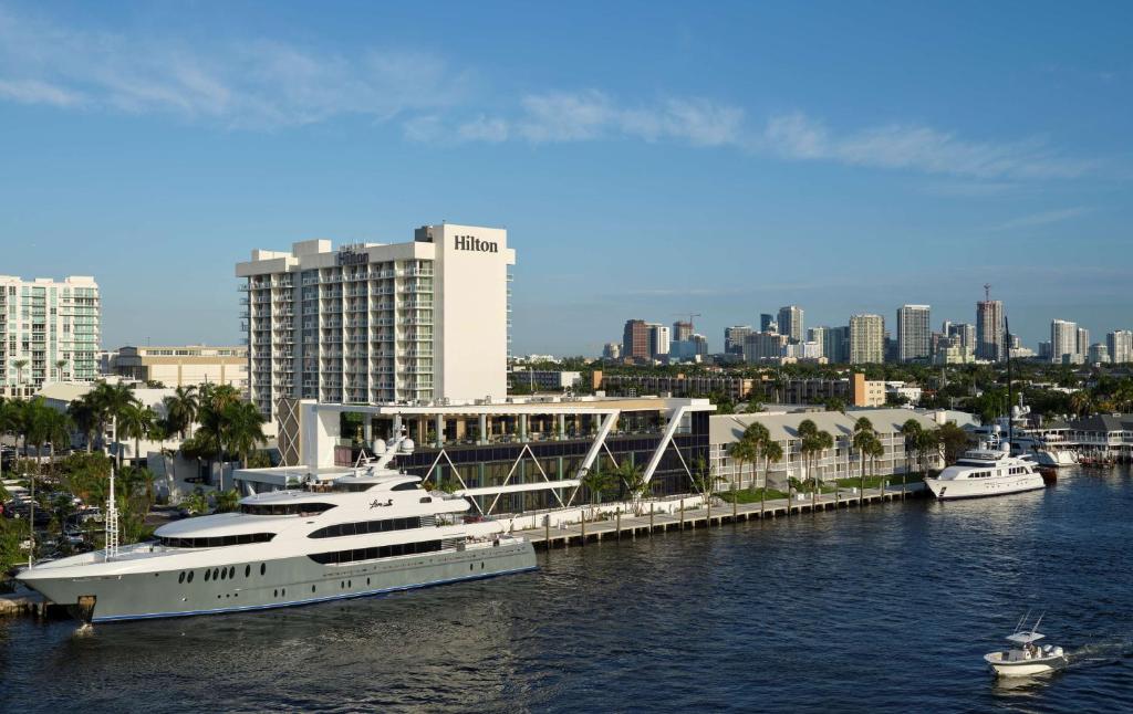 a large yacht docked at a marina in a city at Hilton Fort Lauderdale Marina in Fort Lauderdale