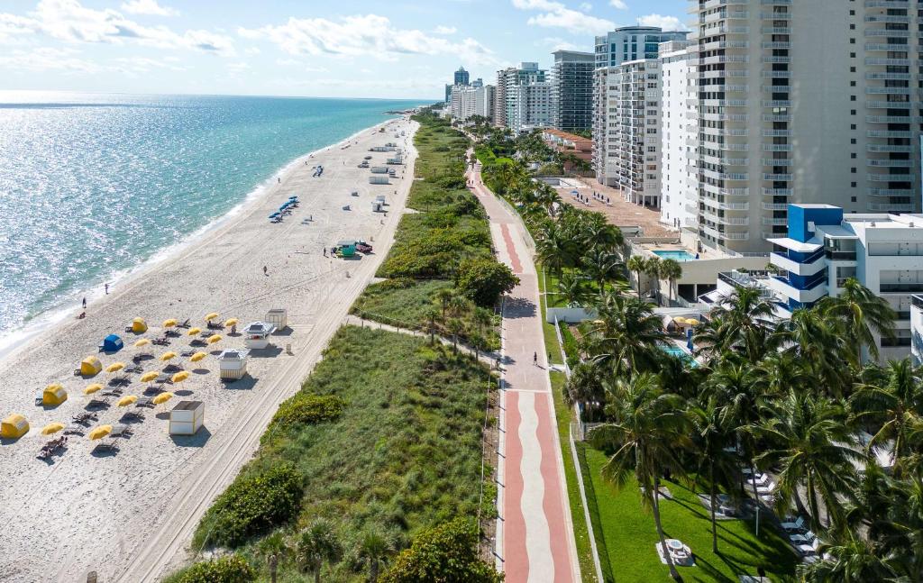 an aerial view of a beach with palm trees and buildings at Hilton Cabana Miami Beach Resort in Miami Beach