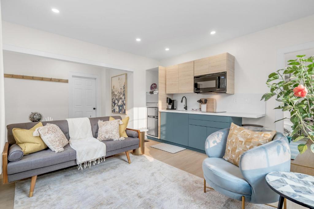 a living room with a couch and two chairs at Beautiful Lakeside Haven in Port Hope