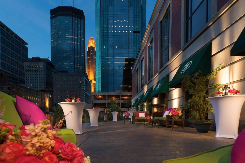 a city street with tables and flowers and buildings at Hilton Minneapolis in Minneapolis