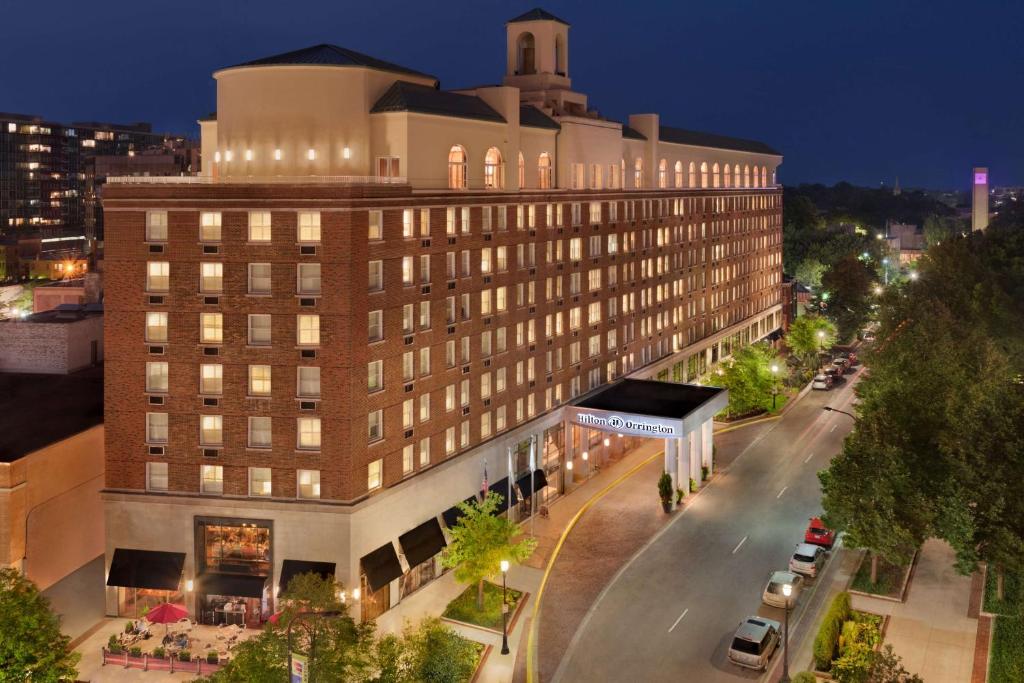 a large building on a city street at night at Hilton Orrington/Evanston in Evanston