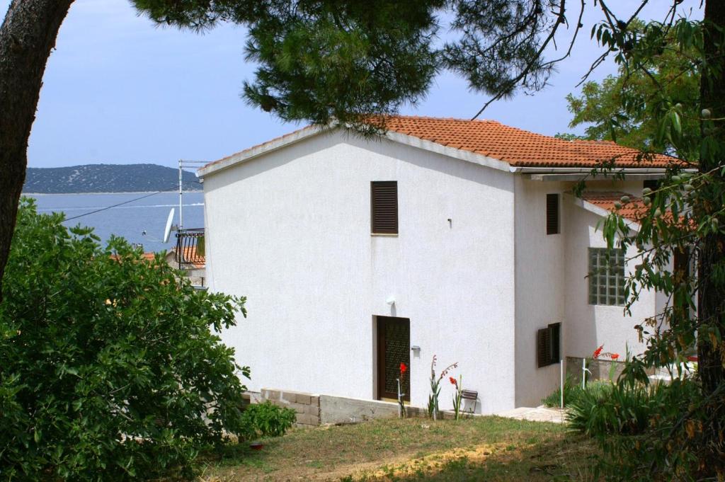 a white house with a view of the water at Apartments by the sea Sepurine, Prvic - 4238 in Prvić Šepurine