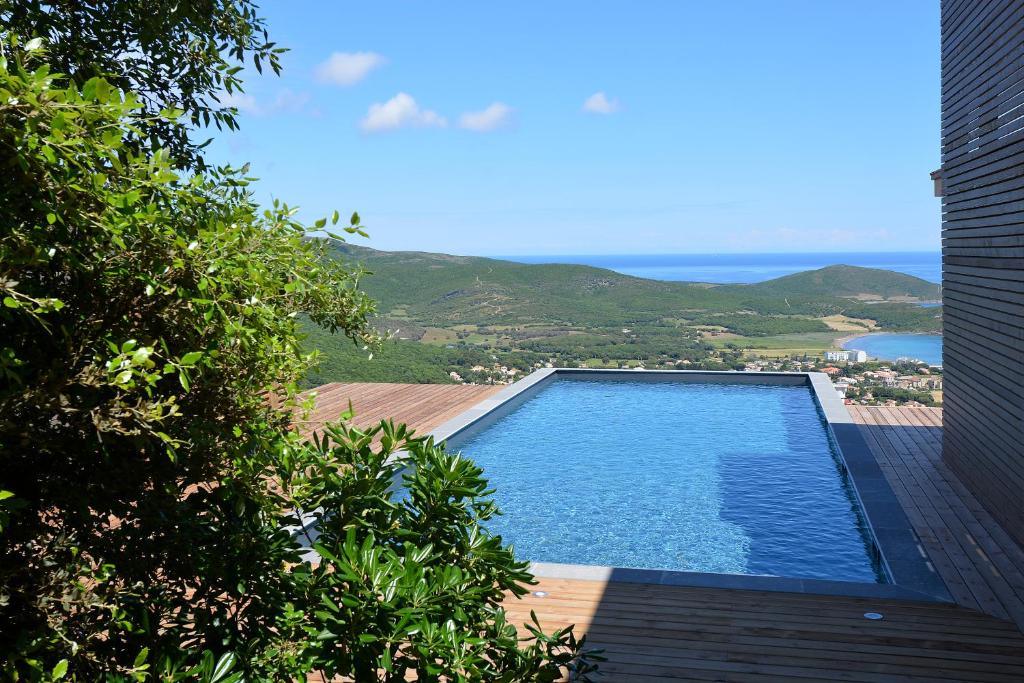 a swimming pool with a view of the ocean at Le Tomino in Macinaggio