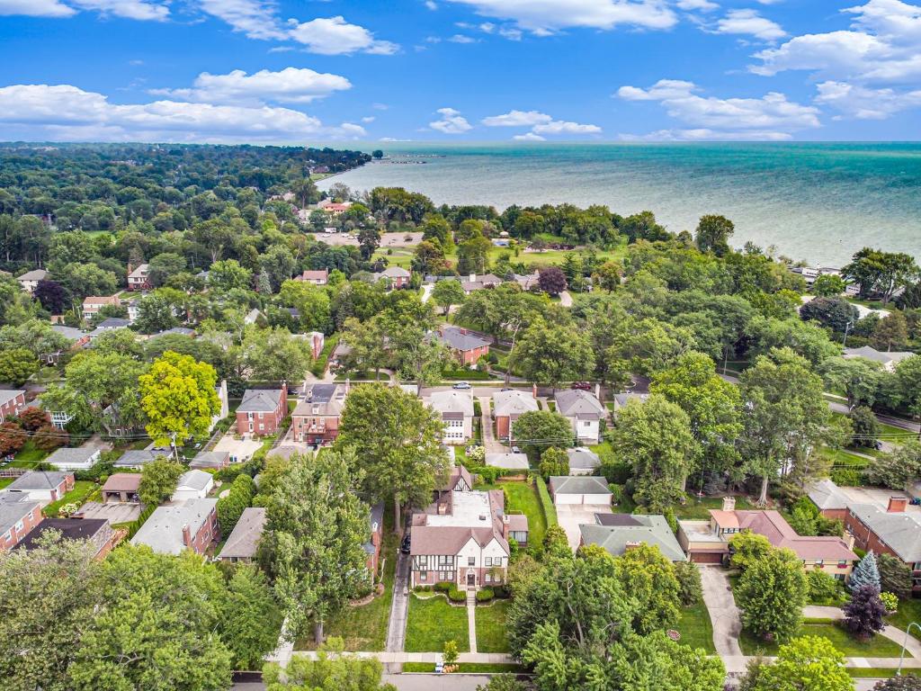 an aerial view of a residential neighborhood with houses and the ocean at Mansion with Pub in Basement in Grosse Pointe Park