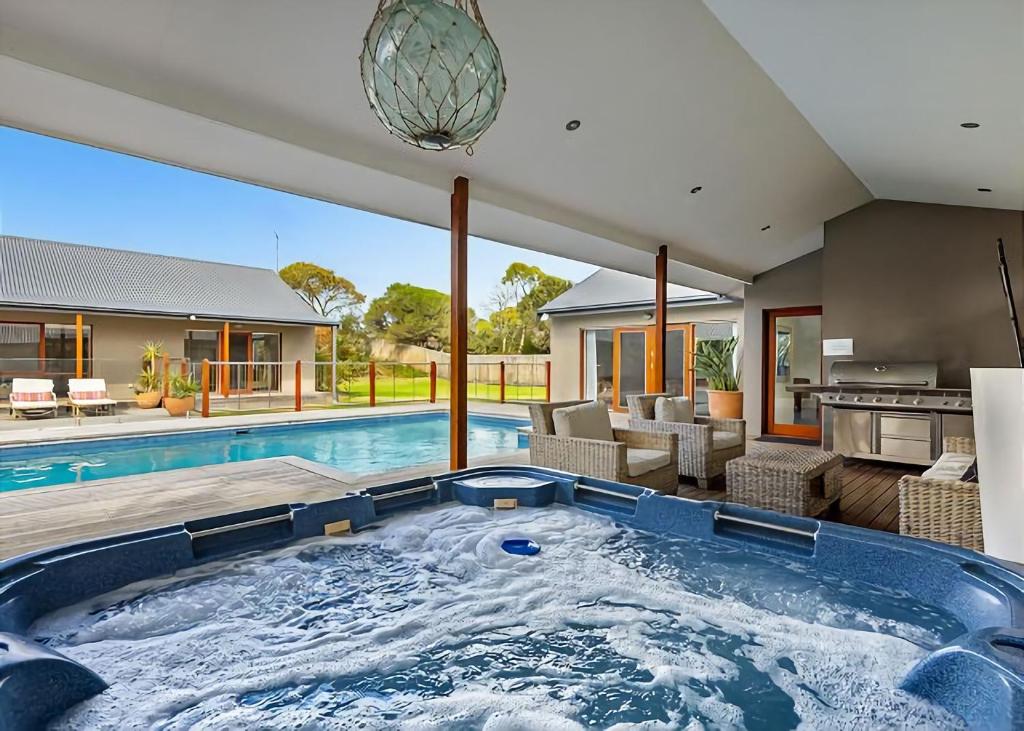 a hot tub in the backyard of a house at Pool Haven on Leah in Rye