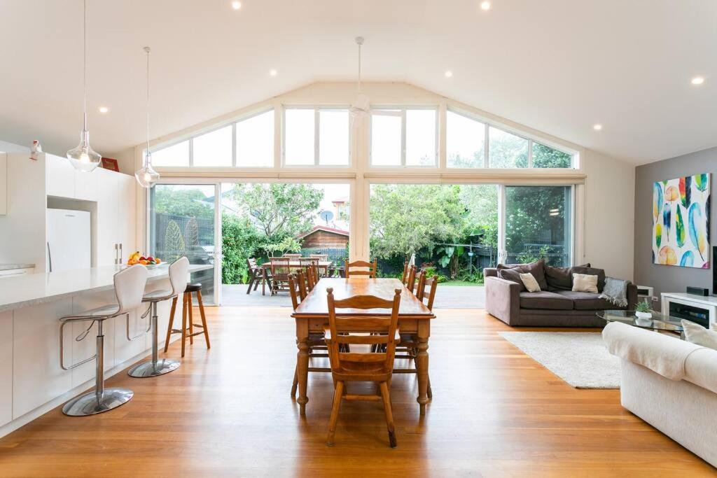 a kitchen and living room with a table and chairs at Beach House Close to Manly in Sydney