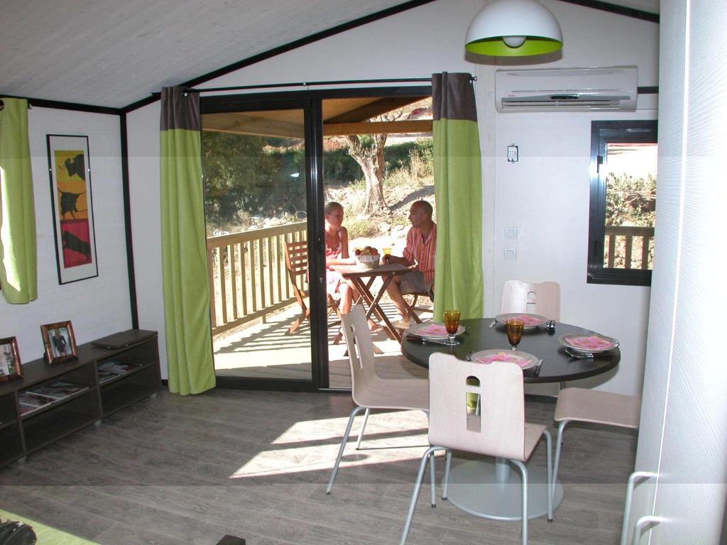 - un salon avec une table et des chaises ainsi qu'une terrasse couverte dans l'établissement Cottage in Provence with Covered Terrace, à Solliès-Toucas