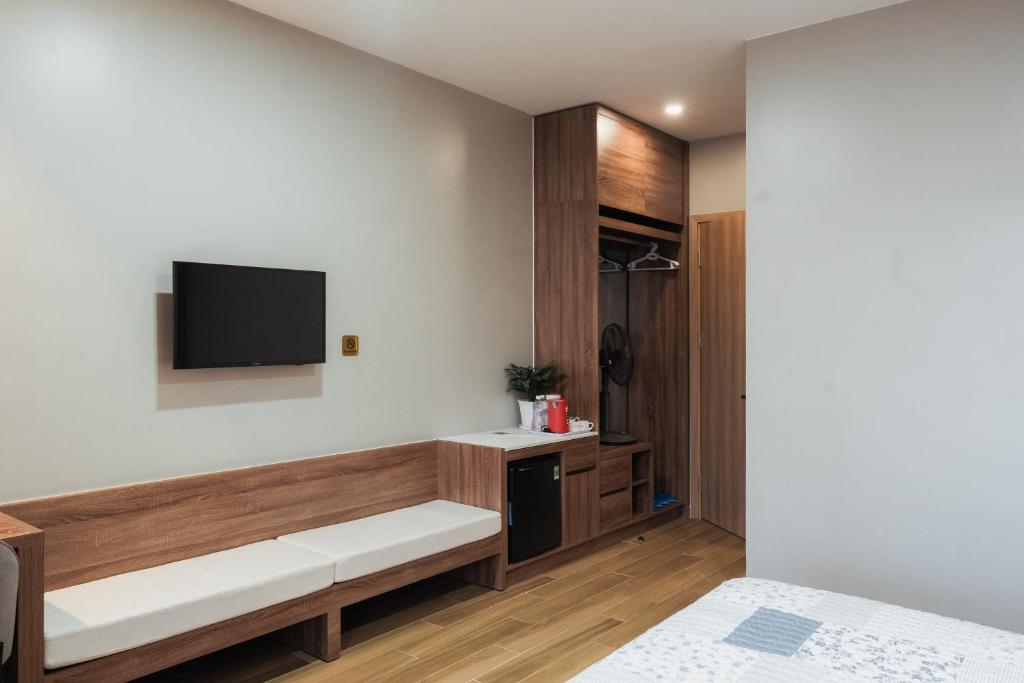 Giường trong phòng chung tại Thảo Nguyên House