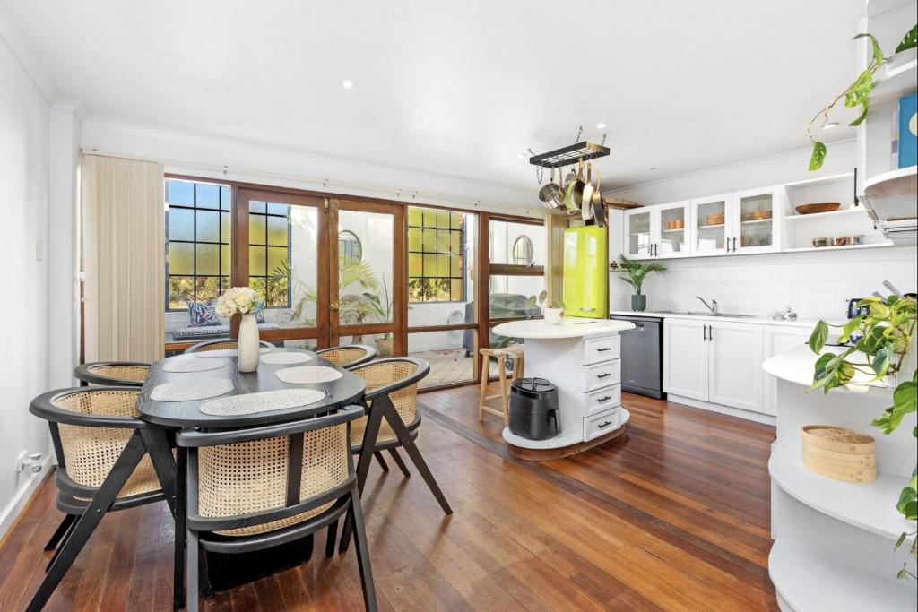 a kitchen and dining room with a table and chairs at 5 North Freo 2br Supercool Pad & Parking in North Fremantle