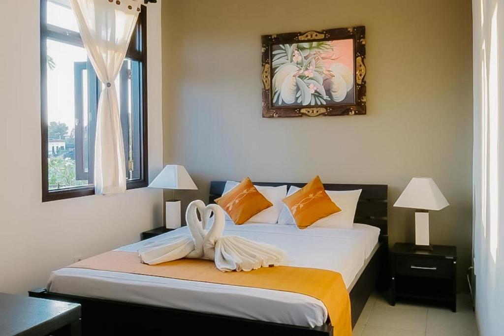 Ένα ή περισσότερα κρεβάτια σε δωμάτιο στο The Lavana Arimanu Kuta