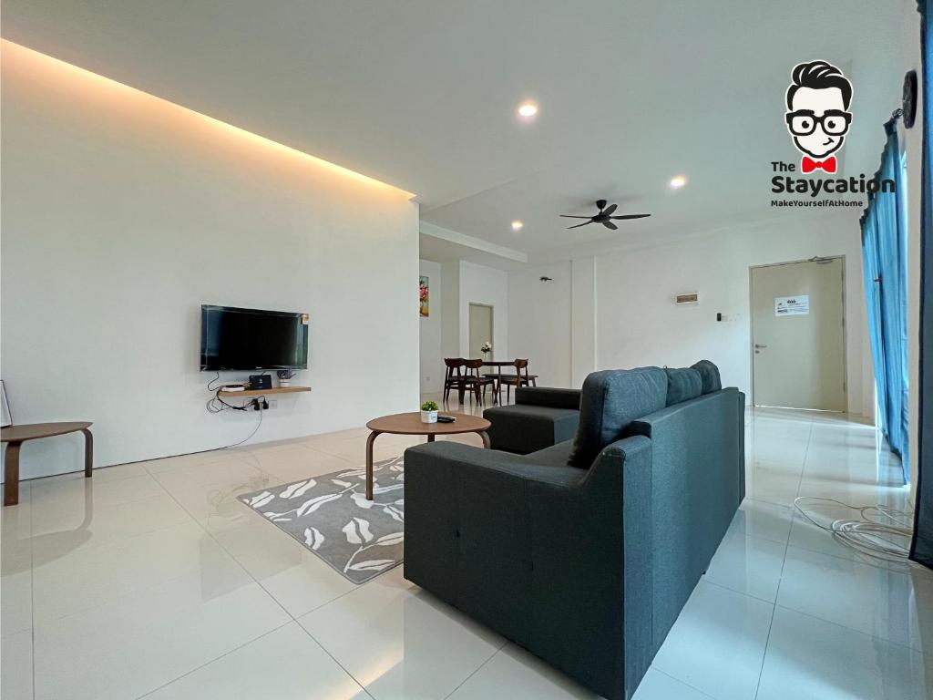 a living room with a couch and a tv at Staycation Homestay 5 Hills 68 Apt Near Imperial in Kuching