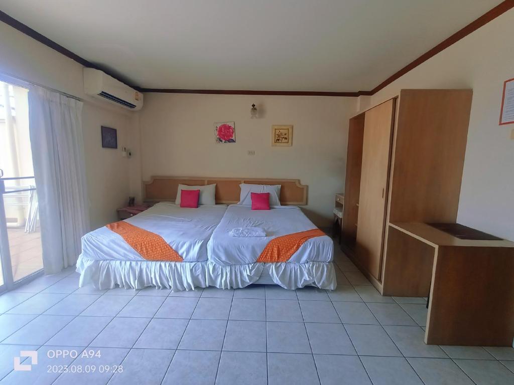 a bedroom with a large bed with pink pillows at SM. Beach Side Place in Hua Hin