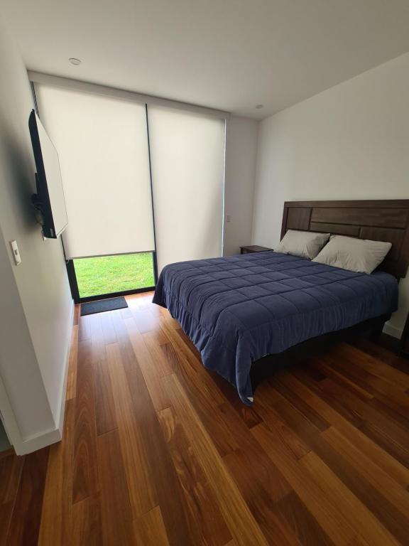 a bedroom with a bed and two large windows at Miraflores habitación separada con privacidad dentro de departamento compartido in Lima