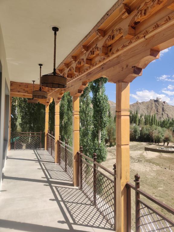 a wooden pergola with a fence on a patio at The Morning Sky hotel in Leh