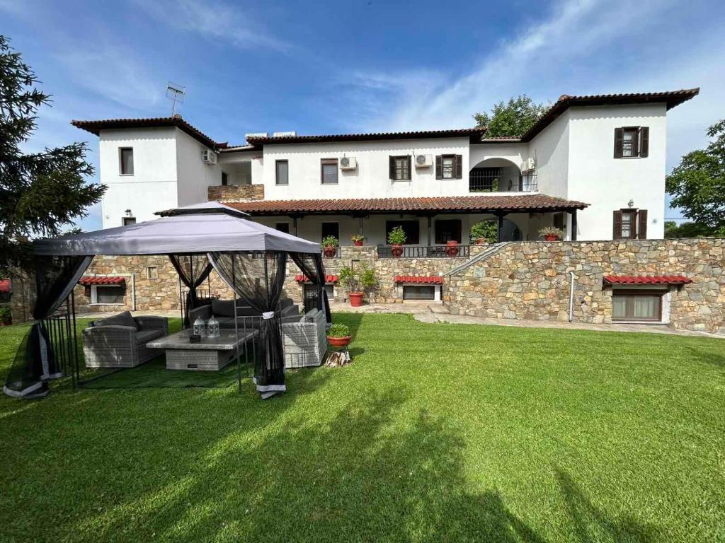 a gazebo in the yard of a house at Studios Filio Sonia in Vourvourou