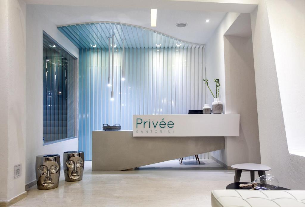 a lobby with a pierce pharmacy sign on a counter at Privée Santorini in Perissa