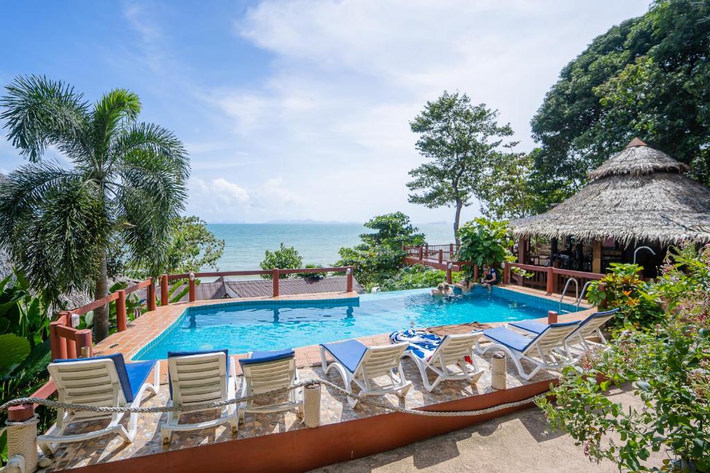 a swimming pool with chairs and a gazebo at Koh Jum Resort in Ko Jum