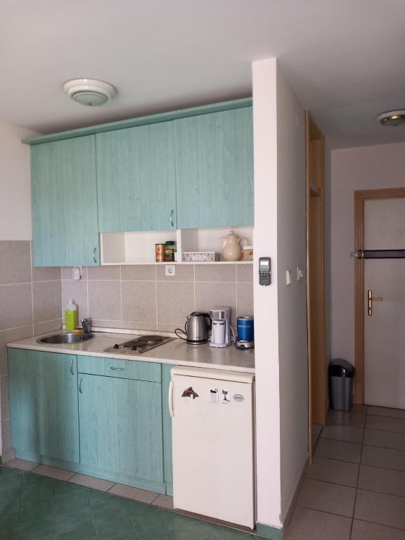 a kitchen with blue cabinets and a counter top at Apartment Budva in Budva