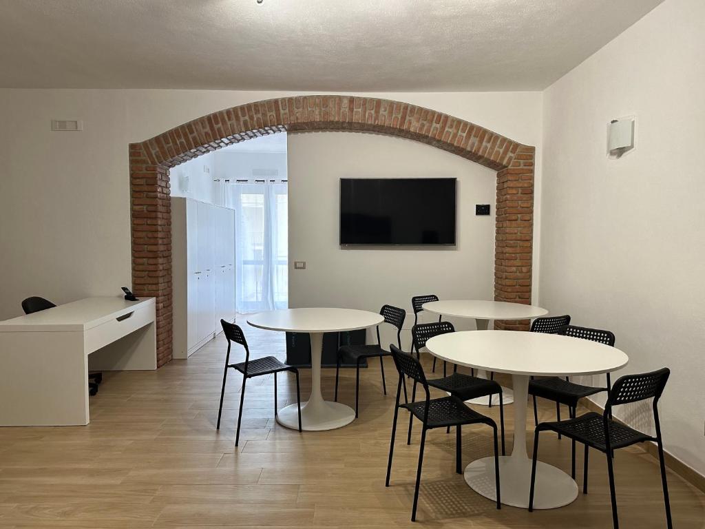 uma sala de jantar com mesas e cadeiras e uma televisão em B&B Ciolandrea em San Giovanni a Piro