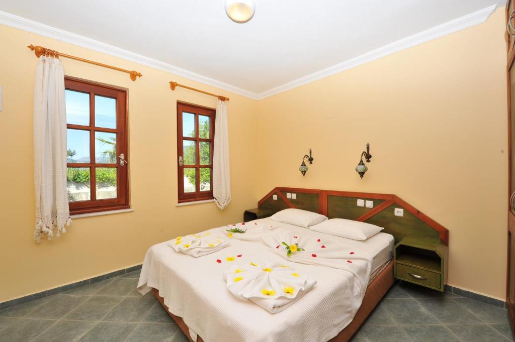 Postel nebo postele na pokoji v ubytování Grenadine Lodge