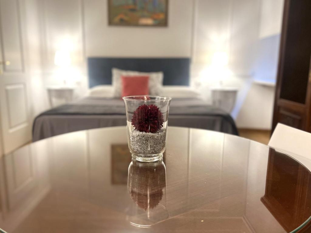 a glass vase with a flower in it on a table at INTERNO ROMA in Rome