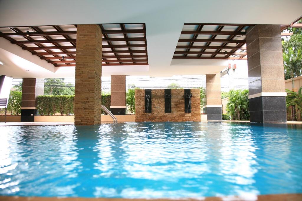 a swimming pool in the middle of a building at Thomson Residence Hotel in Bangkok