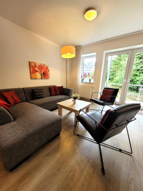 a living room with a couch and a table at Winterberg Appartement 21085 in Winterberg