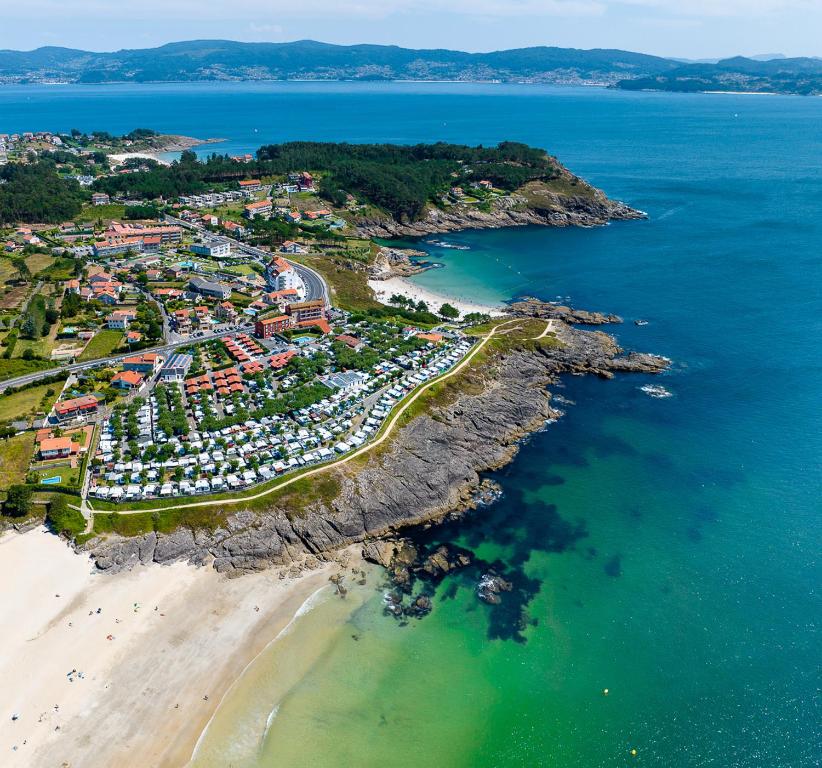 an aerial view of a resort on a beach at Camping Paxariñas in Portonovo