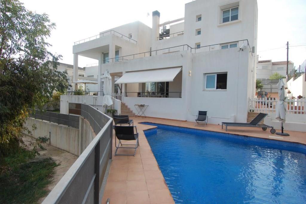 une maison avec une piscine en face d'une maison dans l'établissement Villa Solimar, à L'Ampolla