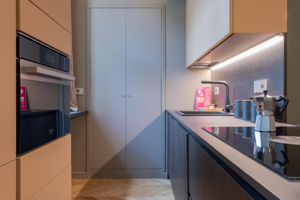 a kitchen with blue cabinets and a counter top at Lagrange Design Apartments by Wonderful Italy in Turin