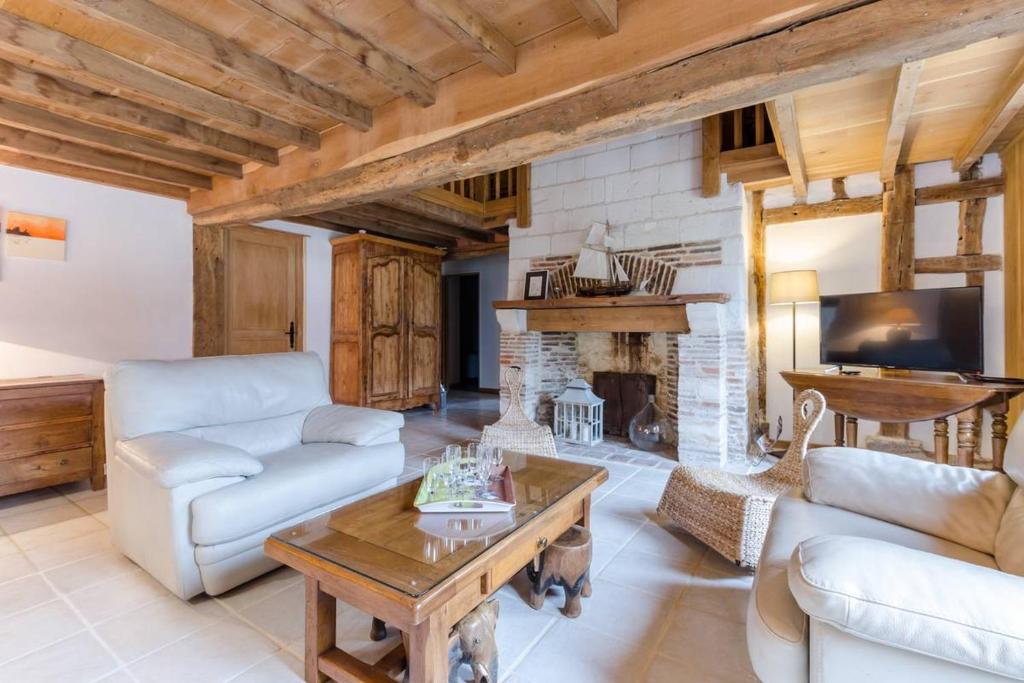 a living room filled with furniture and a fireplace at La ferme d'octave in Dosches