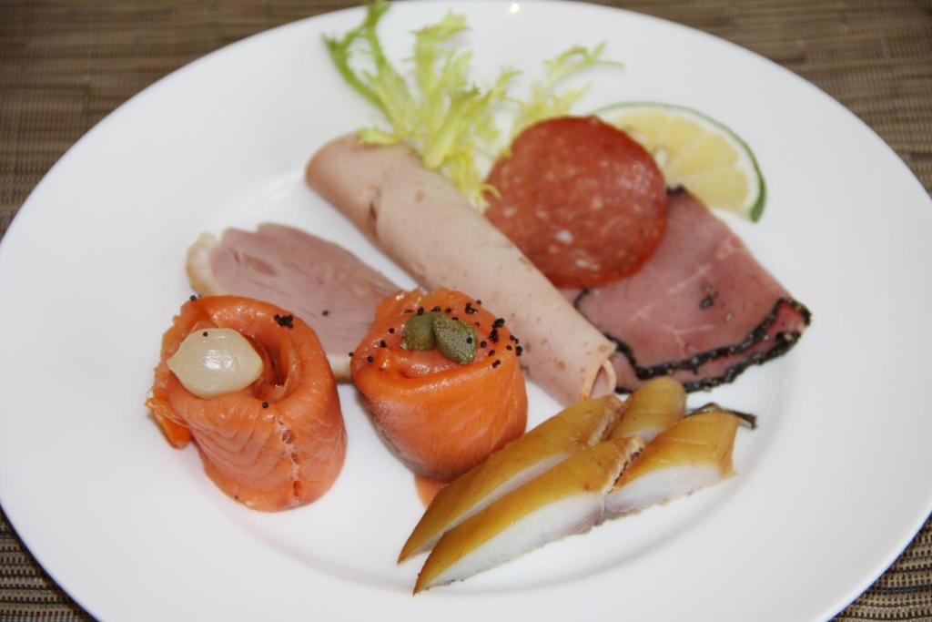 a plate of food with meat and vegetables on a table at Hilton Beijing Capital Airport in Shunyi