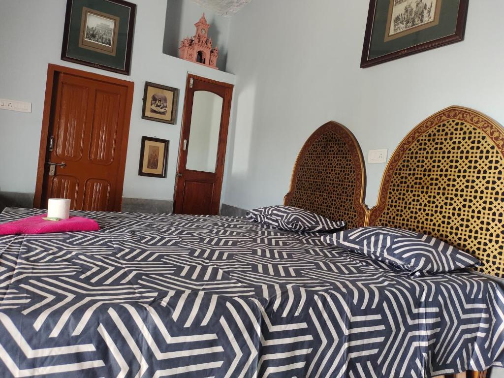 a bedroom with a bed and two chairs at Little prince guest house & homestay in Bikaner