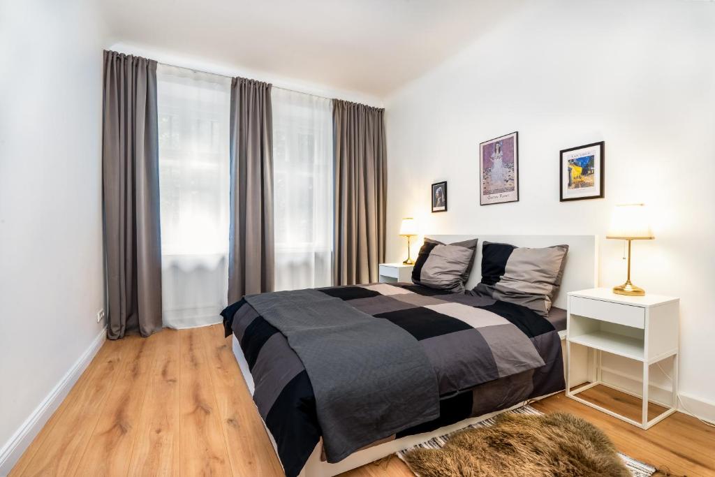 a bedroom with a black and white bed and a window at 2-Room Apartment near Messe and Lietzensee in Berlin