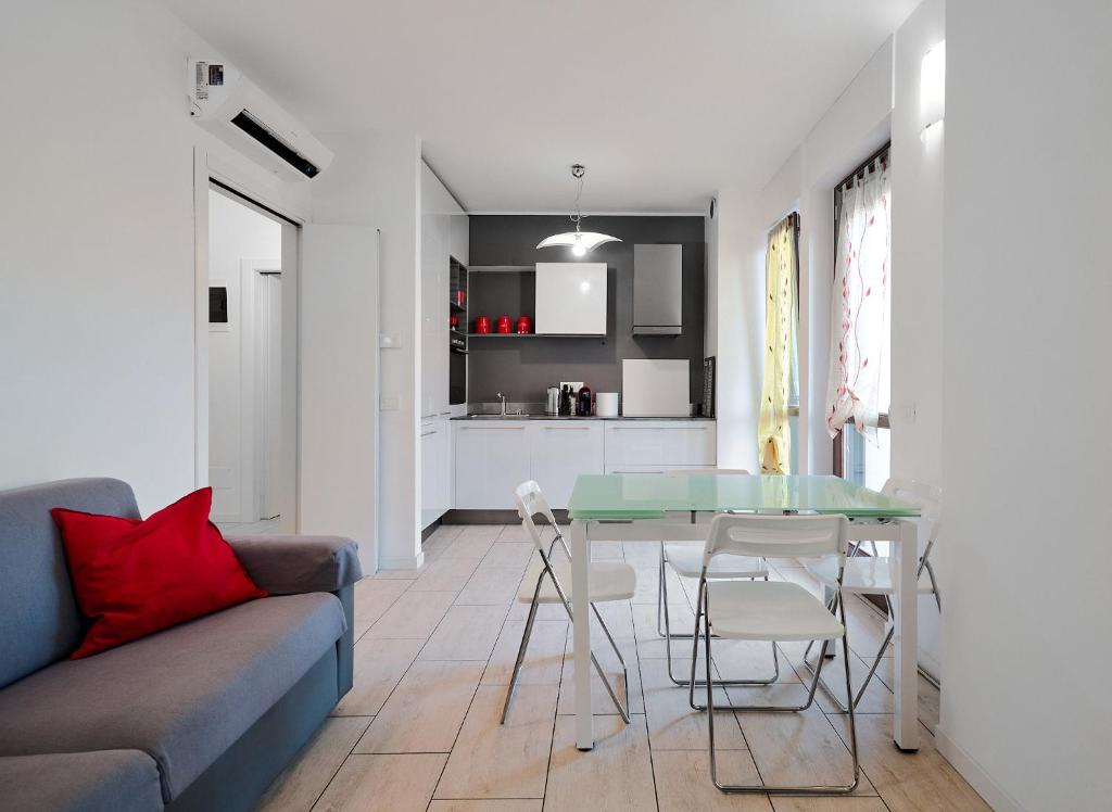 a living room with a couch and a glass table at Xenia Apartments - New and Bright Urban Housing in Milan