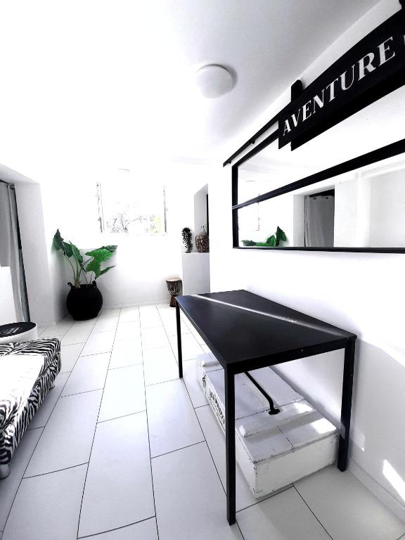 a black piano in a white room with a mirror at Apartments House of Art in Nin