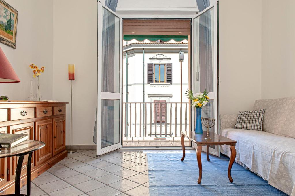 a living room with a couch and a table at La casa di Chiara in Livorno