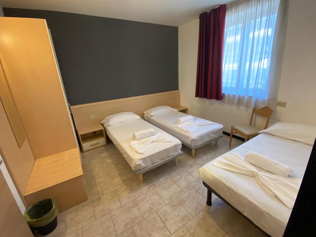 Postel nebo postele na pokoji v ubytování Hotel Mazzini