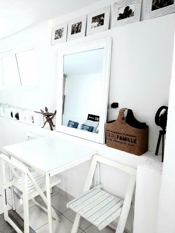 a white dressing table and mirror in a white room at Apartments House of Art in Nin