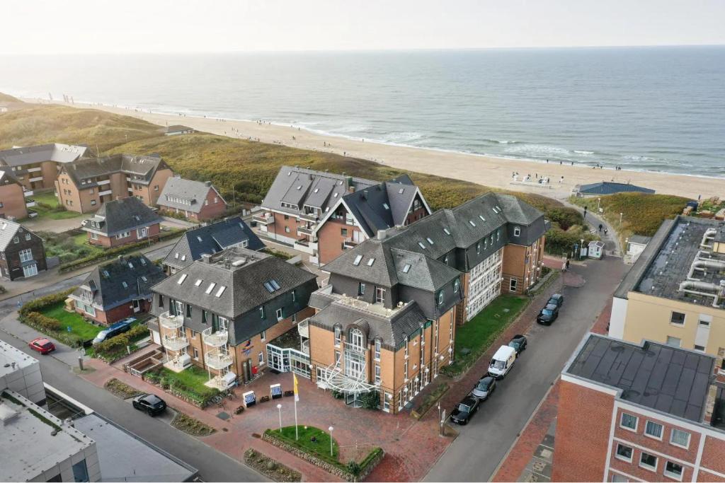 an aerial view of a house next to the beach at Strandhotel Sylt GmbH in Westerland