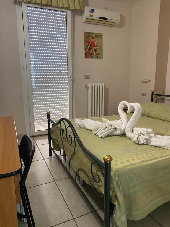 Postel nebo postele na pokoji v ubytování Hotel Esperia